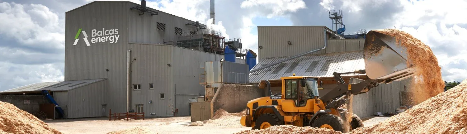 The Balcas Energy wood pellet mill, with a loader moving woodchip